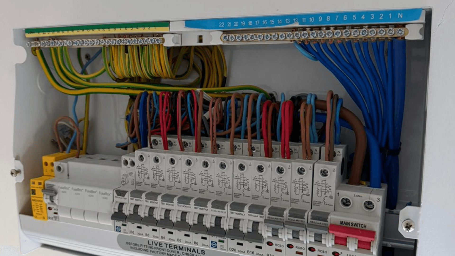 Consumer unit after cable tidying with neatly arranged wiring and protection devices